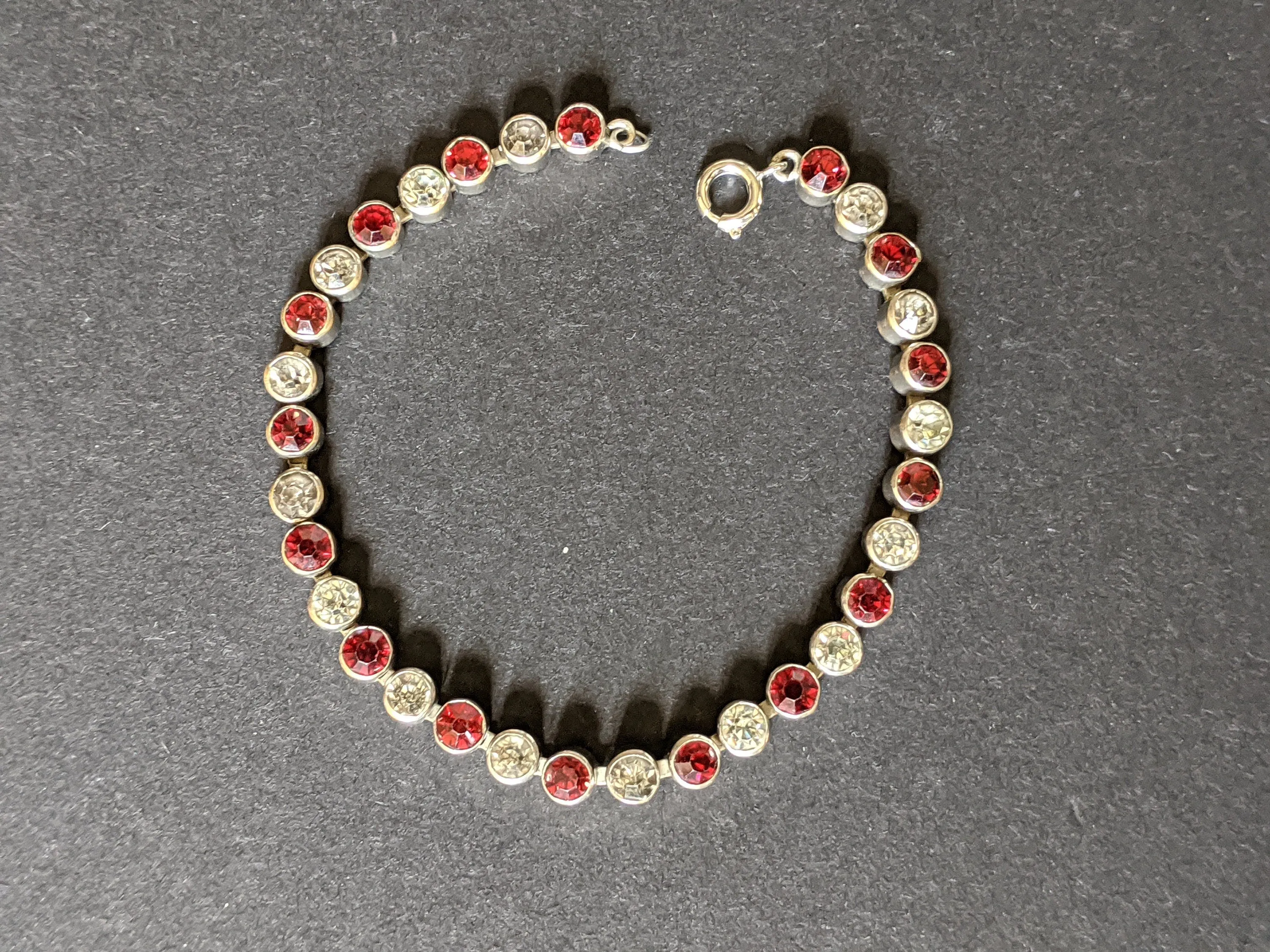 Vintage 1930s Art Deco collet set bright ruby red and clear rhinestone and silver tone tennis / cocktail bracelet